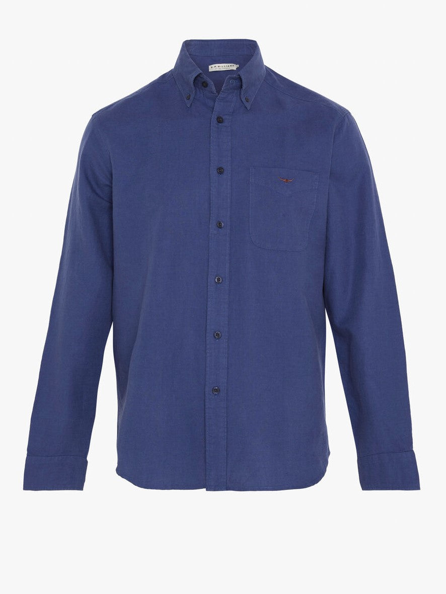 The RM Williams Collins Shirt is a long-sleeved, solid navy blue shirt with a chest pocket and classic button-down collar, shown on a plain white background.