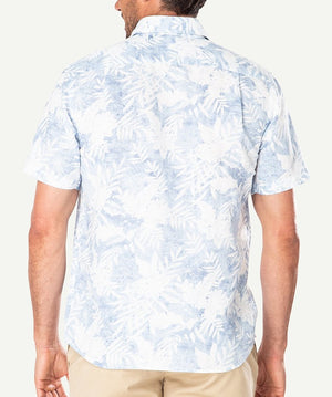 A man is seen from behind wearing the Gazman Linen Blend Palm Print Shirt, a light blue and white short-sleeve button-up with a tropical leaf pattern. The linen-cotton shirt is paired with beige pants against a plain, light background.