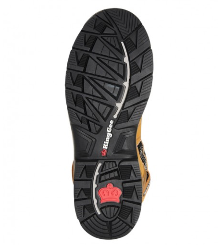 The image displays the sole of the King Gee Quantum Safety Boot. The sole showcases a black, rugged, non-slip tread pattern incorporating a blend of linear and geometric shapes. Designed with shock-absorbing impact properties, the branding "KingGee" is prominently featured in white along with a red crown logo near the heel.