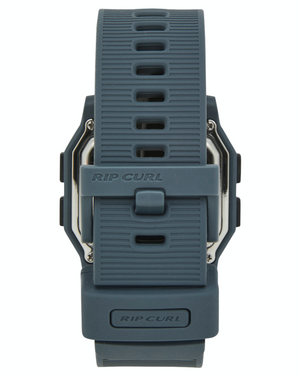 A close-up view of the back of the dark gray Rip Curl Atom Digital Watch, showing a textured, waterproof silicone strap with "RIP CURL" embossed on both the strap and clasp.