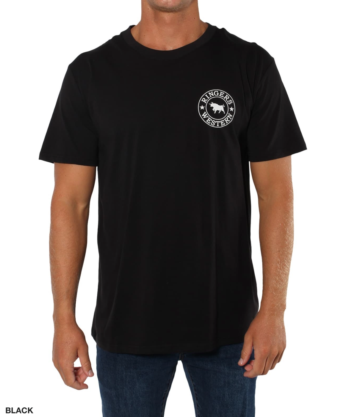 A man wears a Ringers Western Signature Bull Classic T-Shirt, a 100% cotton black tee with a small white "Ringers Western" emblem on the left chest, paired with dark blue jeans. He stands against a crisp white background, embodying casual yet polished style.
