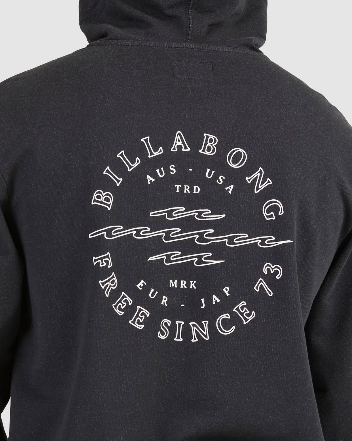 Back of a black Billabong Big Wave Dan Hood features the logo, wavy lines, and "BILLABONG AUS-USA TRD MRK EUR-JAP FREE SINCE 73" in white—ideal as a casual hoodie with soft fleece lining.