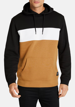 A person is wearing the Connor Downtown Sweat: a color-block hoodie with a black top, white stripe, tan bottom, cozy fleece lining, front pocket, and black drawstrings. They face forward with hands relaxed.