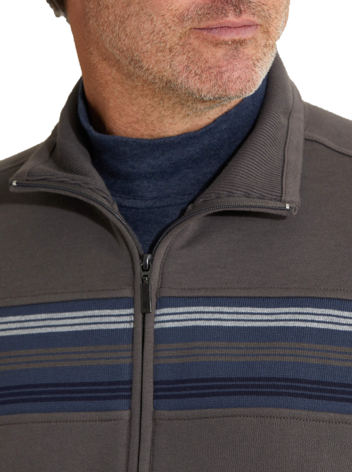 A man wearing the Breakaway Hils Snowy Mt Fleece Jacket, a gray zip-up sweater with blue horizontal stripes, over a dark blue turtleneck.