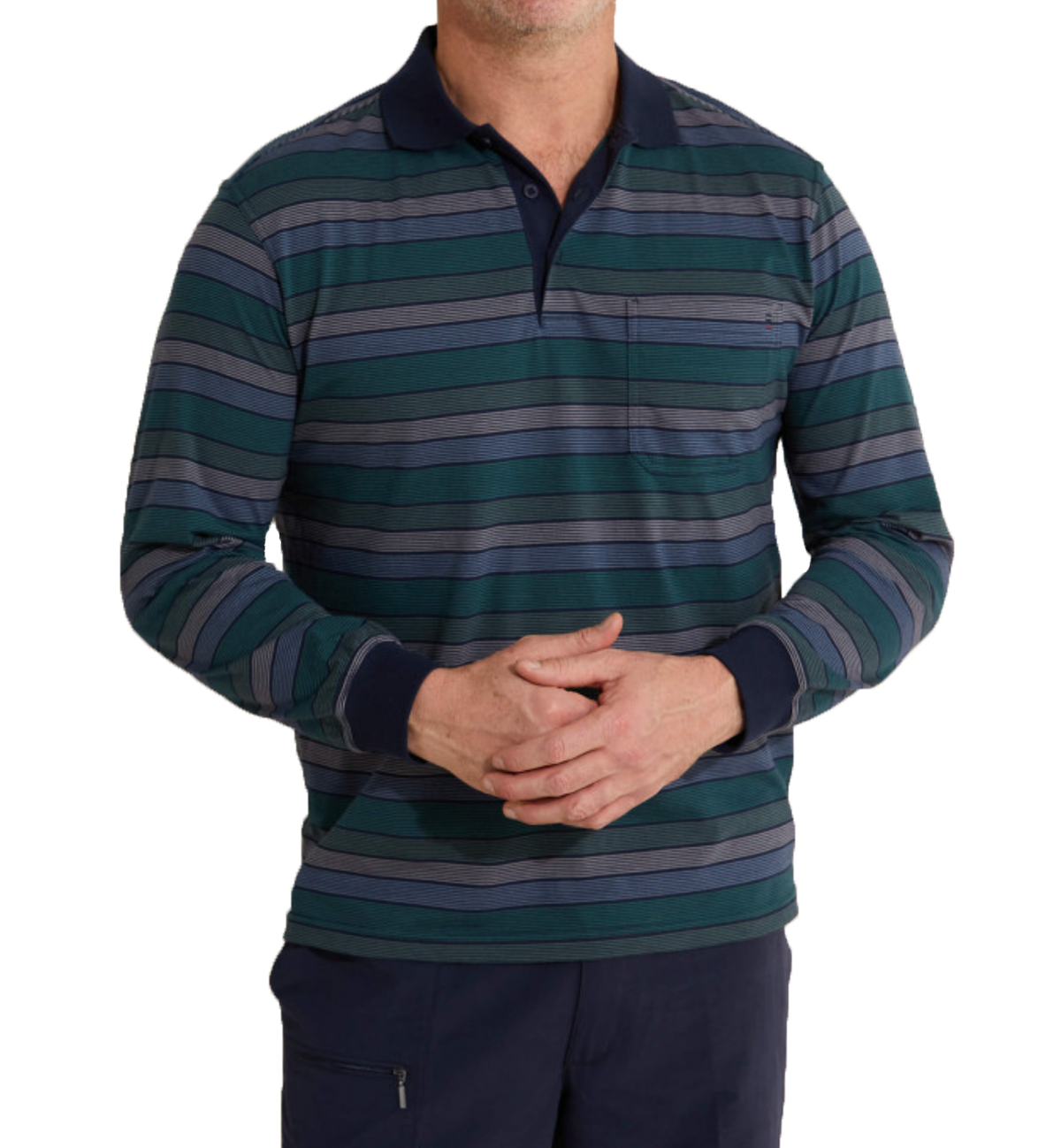The individual, standing with hands clasped in front, is wearing a Breakaway Roe Kinnersly Jersey Polo. This long-sleeve polo shirt features blue, green, and gray horizontal stripes along with dark blue collar and cuffs. It's made from a polyester/cotton blend and includes a small chest pocket. Only the torso and part of the legs are visible.