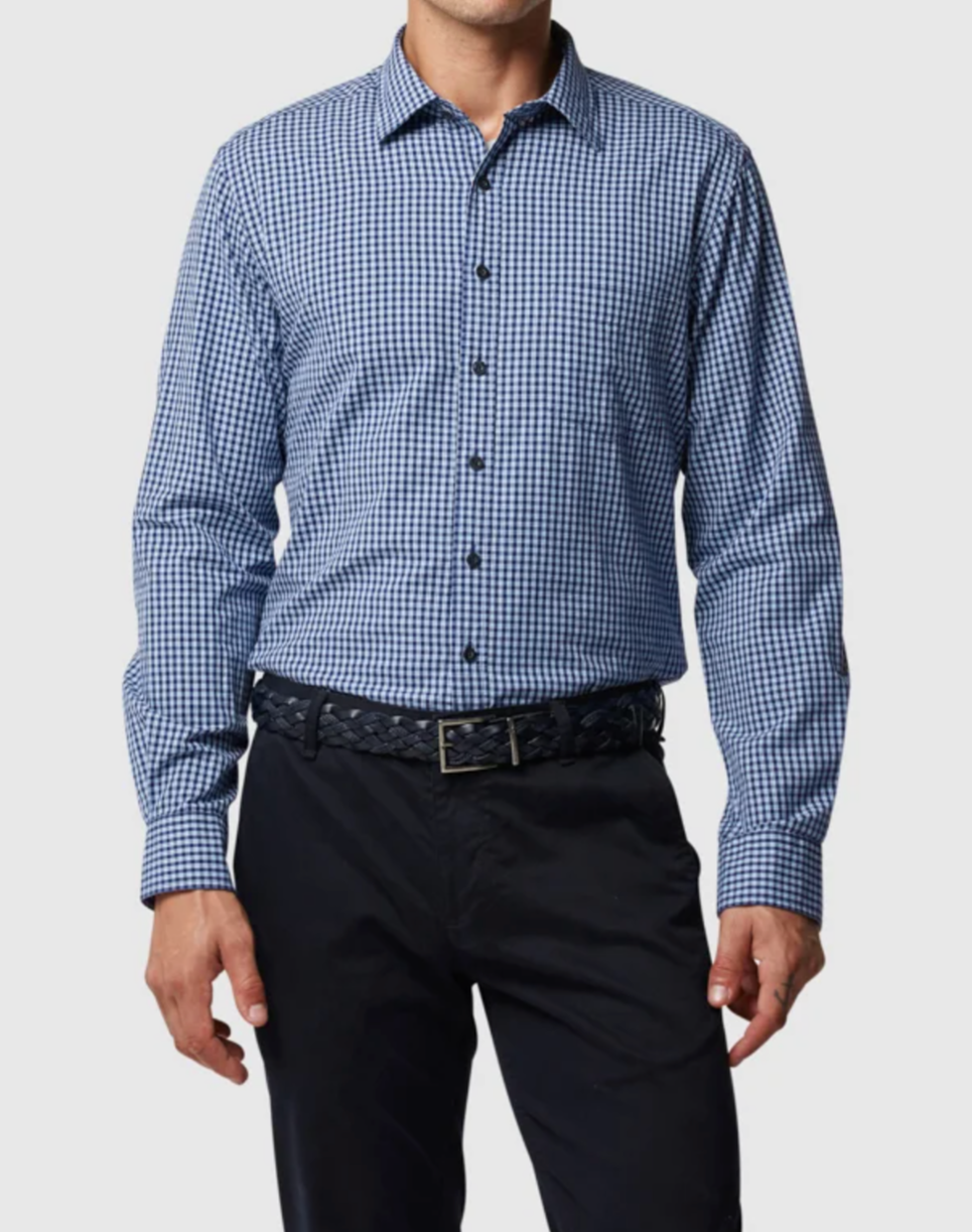 Someone models the Rodd & Gunn Humbler Shirt, a blue and white checkered 100% cotton button-up with long sleeves and a collar, paired with dark pants and a belt.