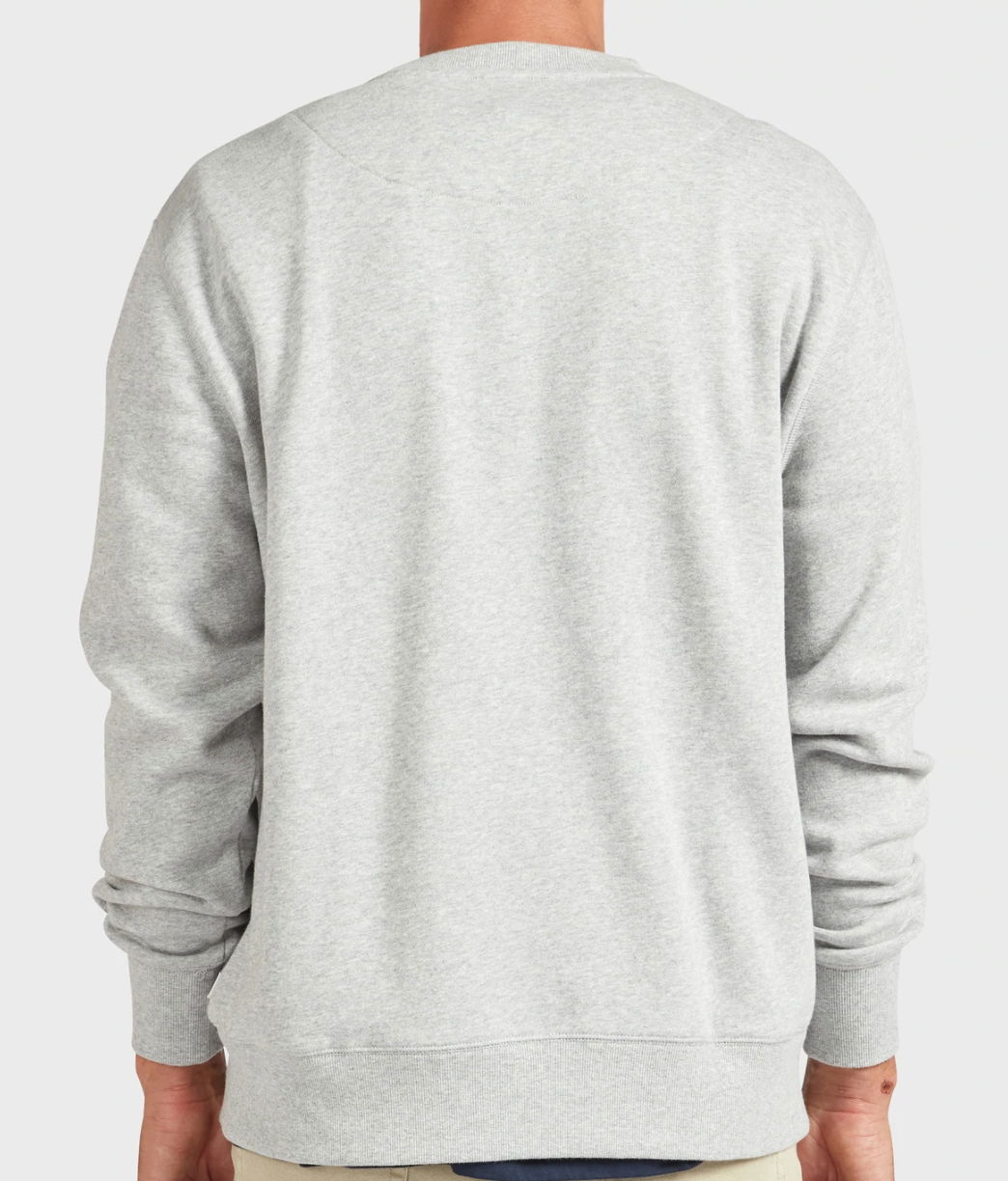 A person is seen from the back wearing the Academy Brand College Crew in light gray, highlighting its long sleeves and ribbed cuffs against a simple, uncluttered background.