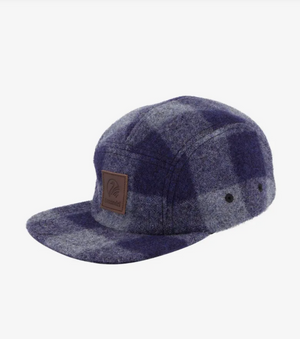 The Swanndri Wentworth Valley Cap, featuring a blue and gray plaid design in 100% wool, is a stylish five-panel cap with a flat brim and two metal eyelets on the sides for added ventilation. Adding to its unique look, it boasts a brown leather patch embossed with the Swanndri logo.