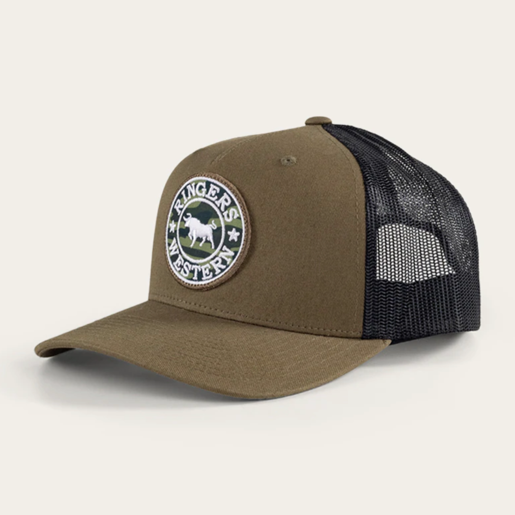 The Ringers Western Chase Trucker Cap features a brown front, black mesh back, and circular patch with an animal silhouette and "Ringers Western." It has an adjustable strap and is set at a slight angle on a plain background.