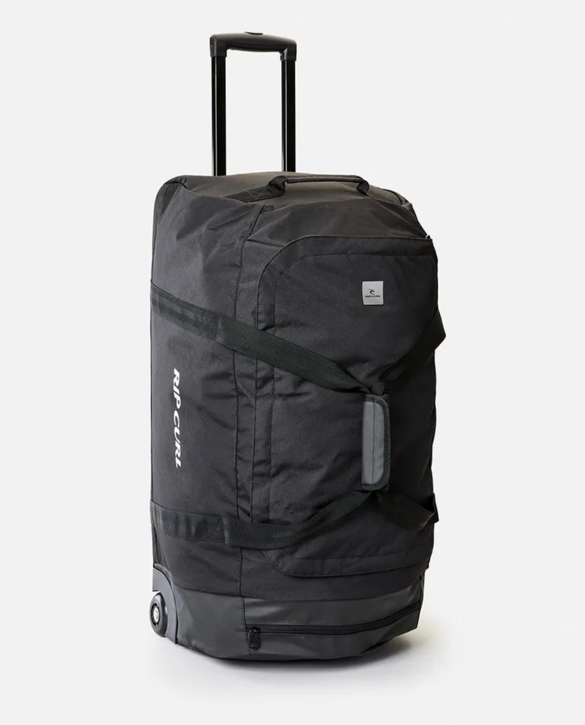The Rip Curl Jupiter 80L Midnight Travel Bag is a black rolling duffle bag with a retractable handle and wheels, crafted from water-resistant ripstop material. It features a large main compartment with a zippered closure and a smaller rectangular logo near the top. The brand name is printed vertically on the side, set against a white background.