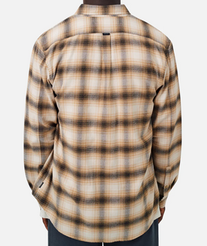 Rear view of a person wearing Industrie The Bates Shirt, a comfortable long-sleeved plaid design featuring beige, black, and brown shades. Made from 100% cotton in a relaxed fit, it pairs perfectly with dark pants against a plain white background.