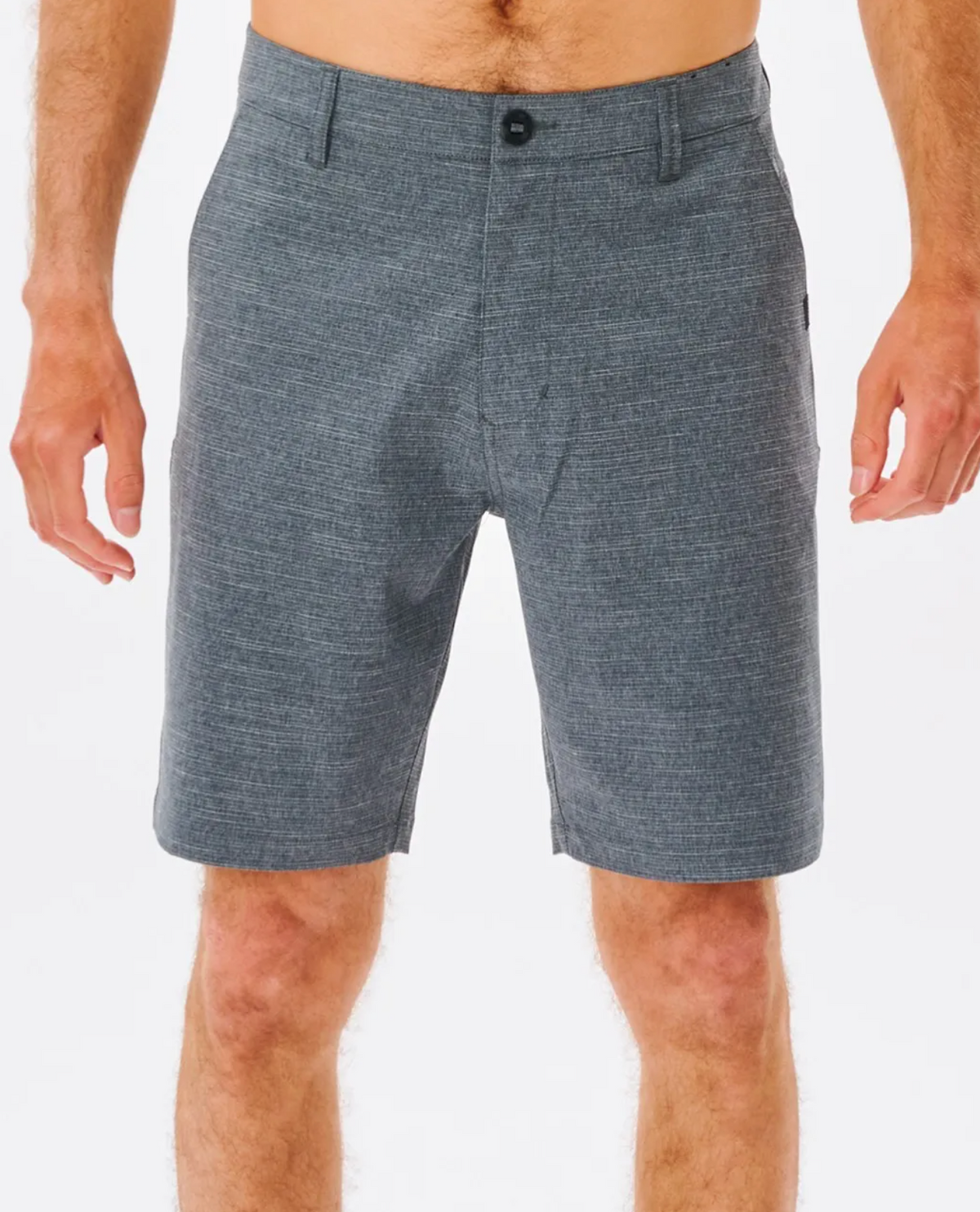 A person in Rip Curl Boardwalk Epic Mix Shorts is against a white background. The gray knee-length shorts, made from quick-dry Stretch Recycled Polyester, have a subtle textured pattern and a buttoned waistband. Their arms rest by their sides, conveying relaxed style.
