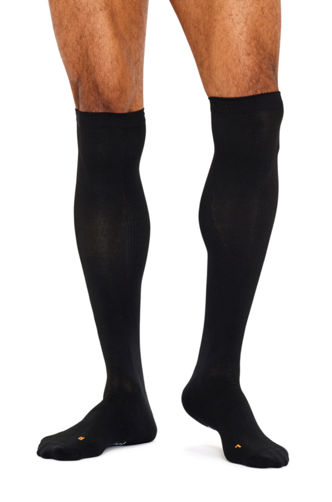 A person wearing Benefeet Therapeutic Compression Knee High Socks is against a white background, showing their legs and feet with toes slightly apart. The anatomically shaped design with targeted compression ensures optimal comfort.