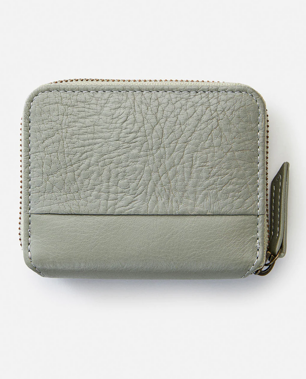 The Rip Curl Small Leather Wallet in gray leather features a textured upper and smooth lower section, an ID window, and a zip-around closure with a zipper pull on the right side against a plain white background.