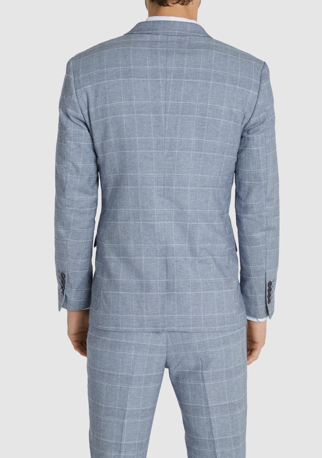 A man is shown from the back wearing the Connor Sorrento Slim Suit Jacket in light blue with a subtle white plaid pattern, featuring buttoned cuffs and matching trousers for a modern, tailored look.