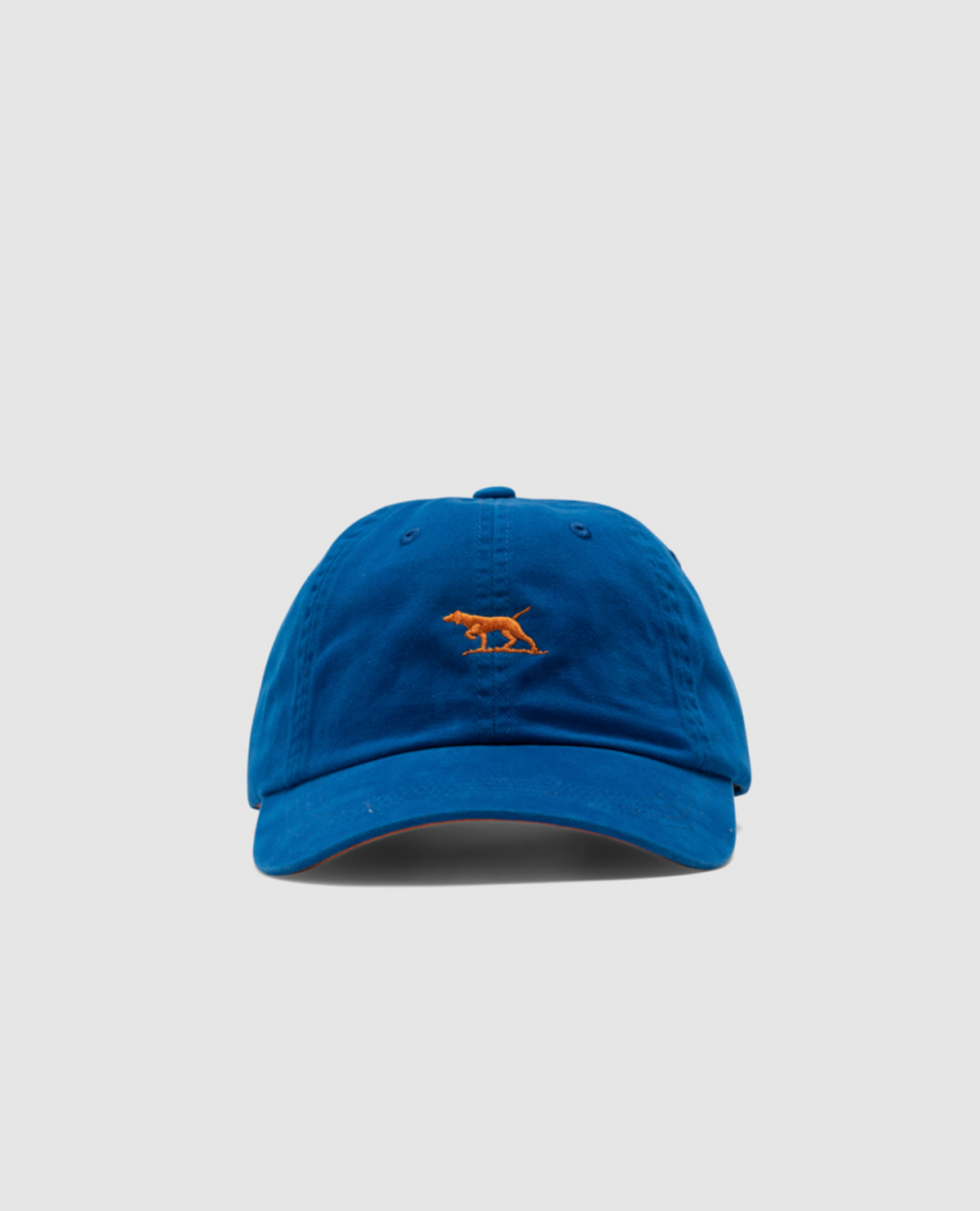 The Rodd & Gunn Gunn Cap, in blue heavy-duty cotton twill, features a bold embroidered orange kangaroo logo on the front, set against a plain gray background that embodies Rodd & Gunn's essence.