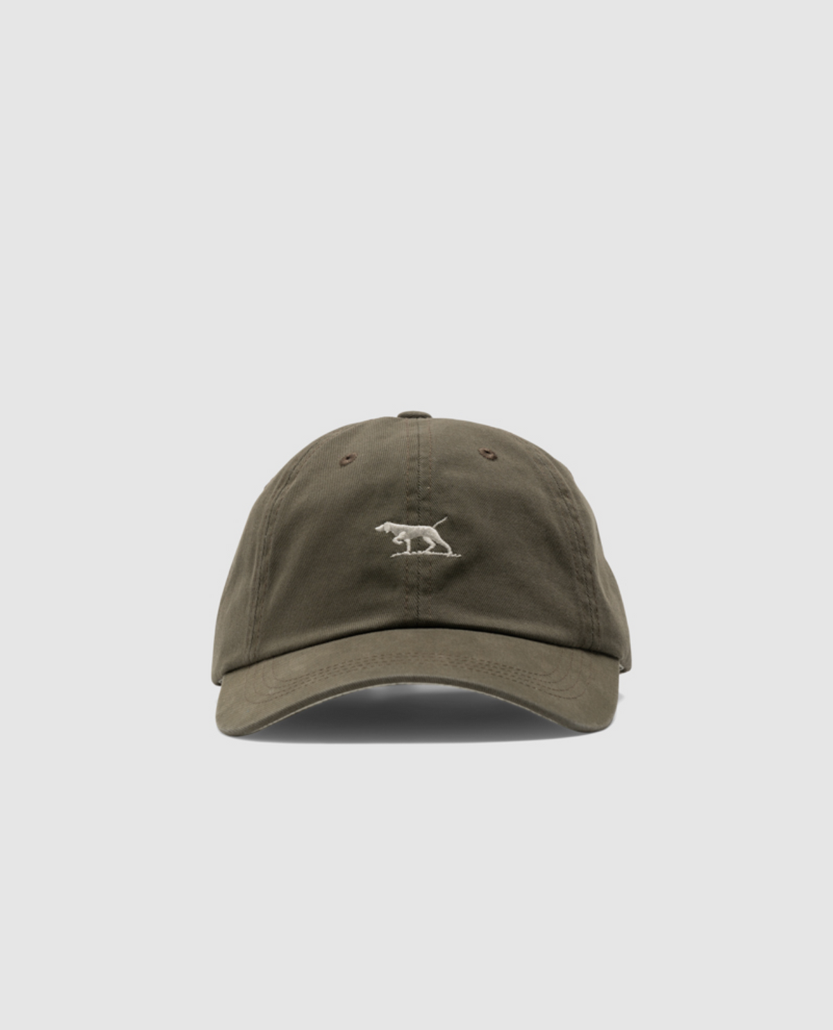 The Rodd & Gunn Gunn Cap, made of heavy-duty cotton twill, has a small embroidered polar bear logo on the front. It features a curved brim, visible stitching, and two ventilation eyelets per side. The cap's plain white background highlights its rugged style.