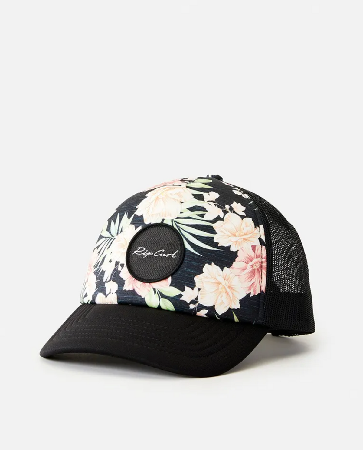 The Rip Curl Sol Seeker Trucker is a black mesh hat with a vibrant floral design of pink and white flowers and green leaves on the front. Made from recycled polyethylene, it features a round black patch with white cursive text at the center.