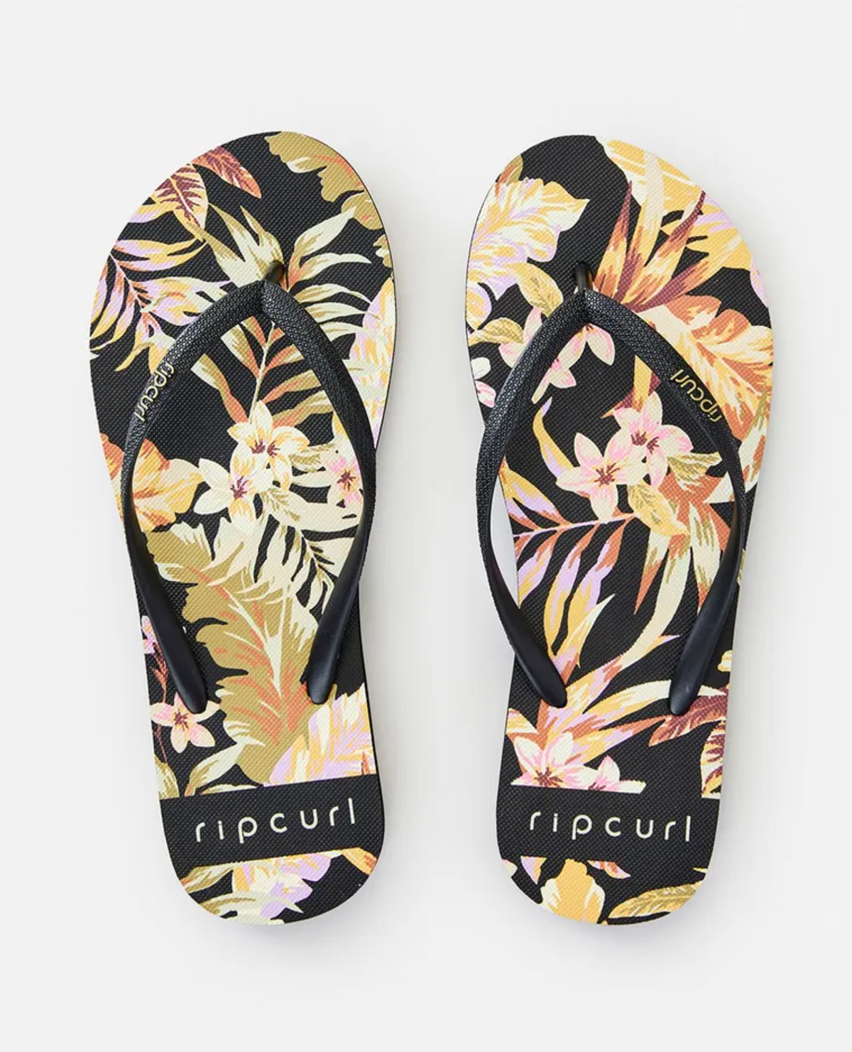 Enjoy the comfort of Rip Curl Sunday Swell Thongs, featuring an ergonomic molded rubber strap and a vibrant tropical floral design in shades of yellow, pink, and tan on the EVA rubber footbed.