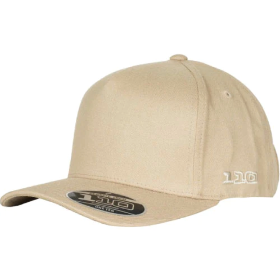 A FlexFit 110 A Frame Cap in beige, featuring a curved brim with a 110 Flexfit sticker on the visor. It has a snapback strap and "110" embroidered on the side.
