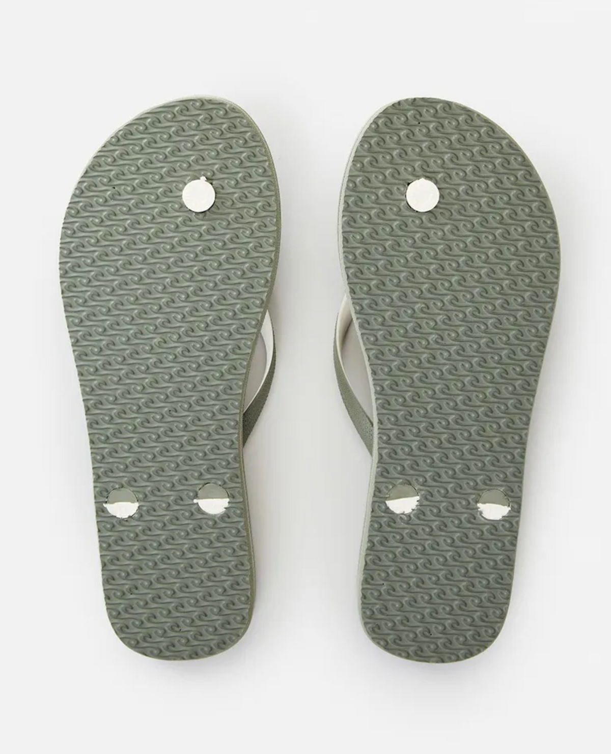 A pair of light green Rip Curl Bondi 2 Tone Thongs shown from the underside. The soles have a textured pattern made from a durable thermo rubber compound, and the back part features circular components where the straps are attached. There are visible wear marks near the back and front ends of these summer essentials.