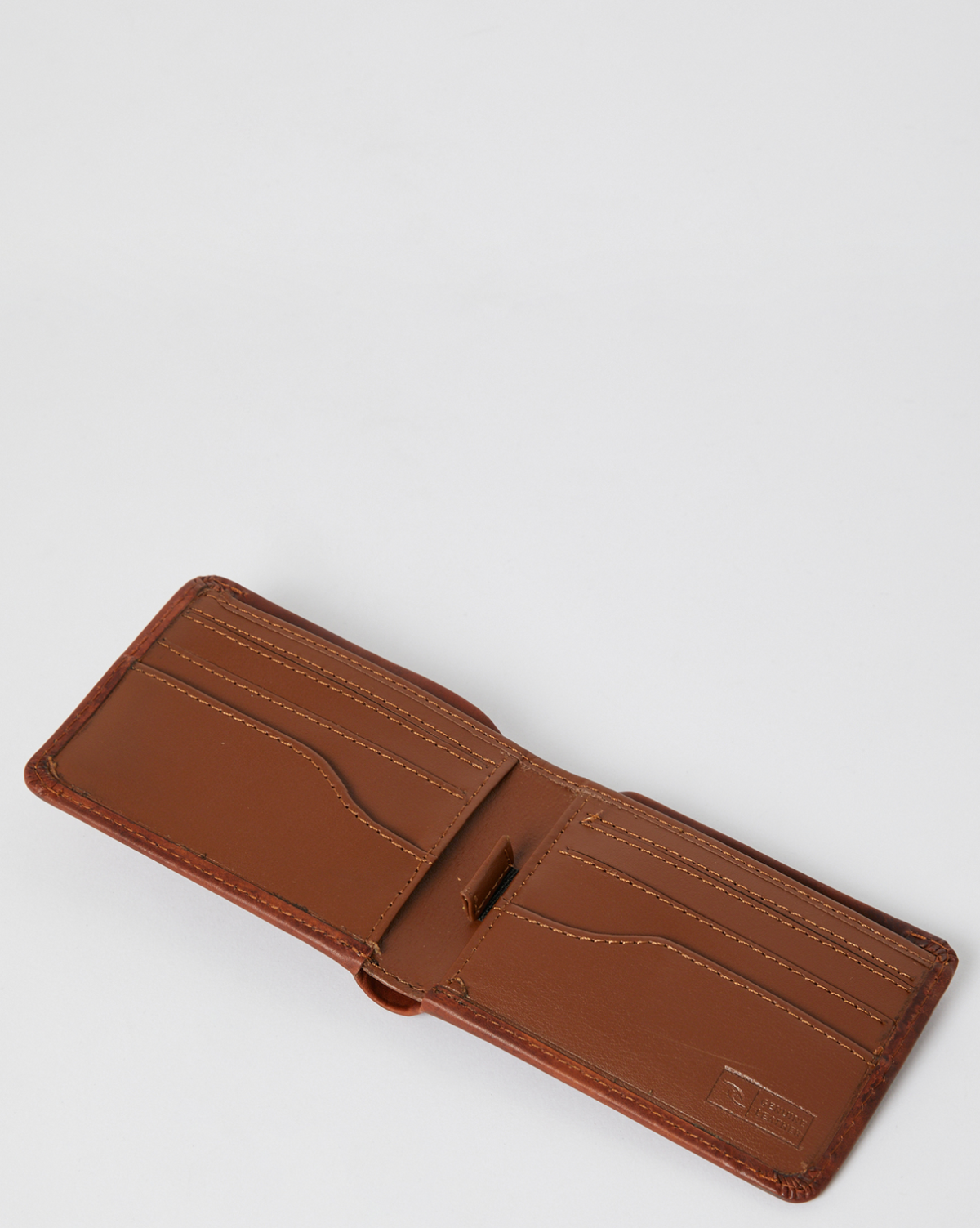 The Rip Curl Corpo RFID Slim Wallet, crafted from brown nubuck leather, is open to reveal multiple card slots and stitched detailing against a plain white background.