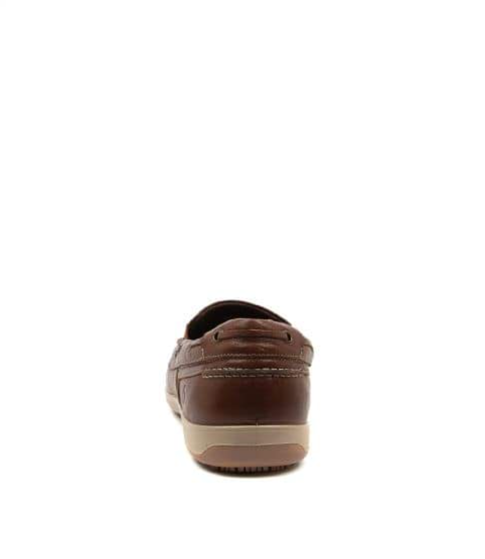 Rear view of the Colorado Broad Slip On Boat Shoe, a brown leather loafer with visible stitching and a tan rubber sole. Designed for slip resistance, it combines a boat shoe style against a white background.