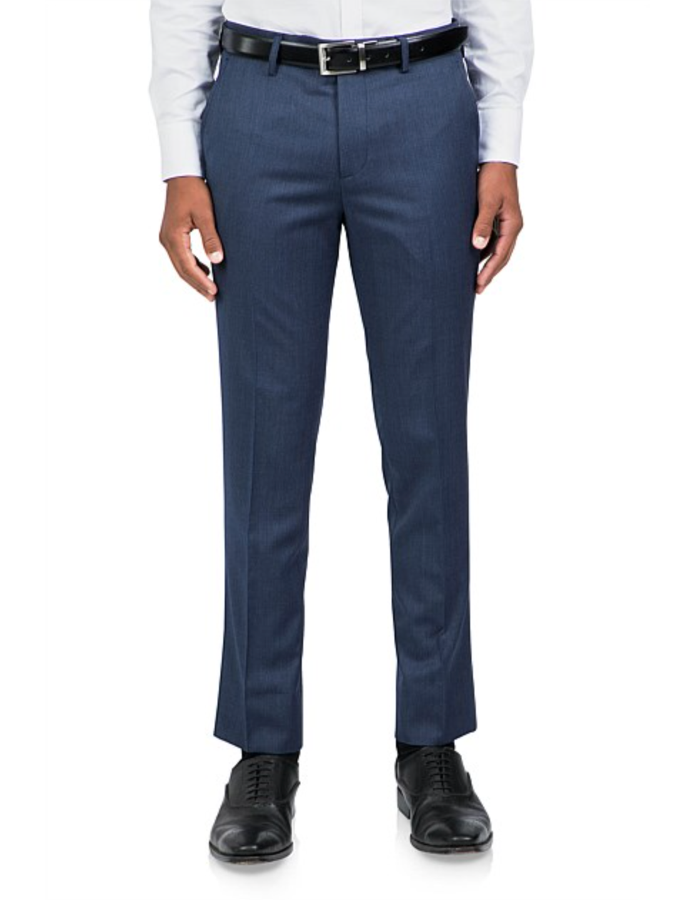 A person is wearing Uberstone Joe Trouser in a tailored slim fit wool blend, paired with a black belt, white shirt, and black dress shoes. They stand against a plain white background.