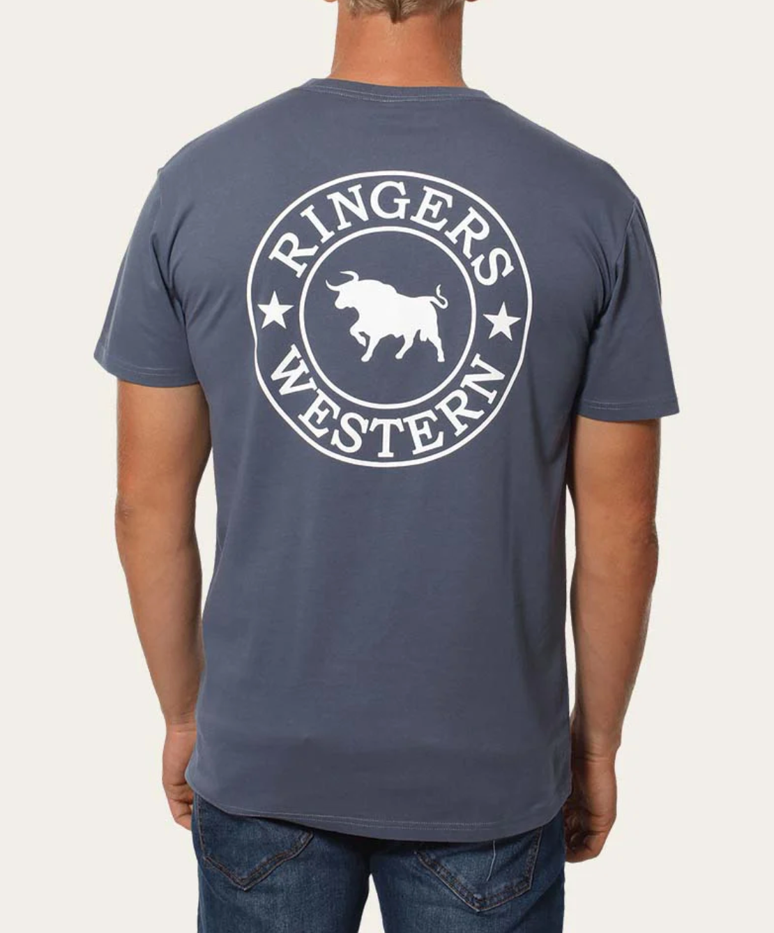 Rear view of a person in the Ringers Western Signature Bull Classic T-Shirt, crafted from 100% cotton, featuring a white circular bull logo and "Ringers Western" text. They're also wearing blue jeans.