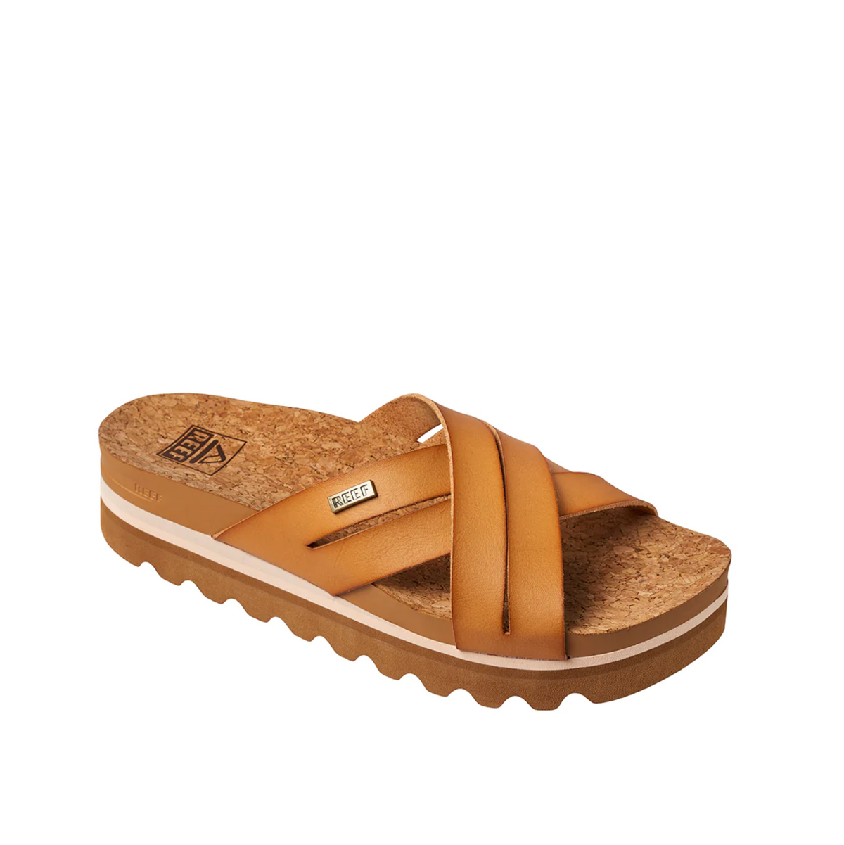 The REEF Cushion Bloom Hi sandal has a brown strapped design, cork footbed, and wavy rubber sole. It features a recycled paper strap with a small label on top and provides unparalleled comfort with its cushion bounce midsole visible in profile.
