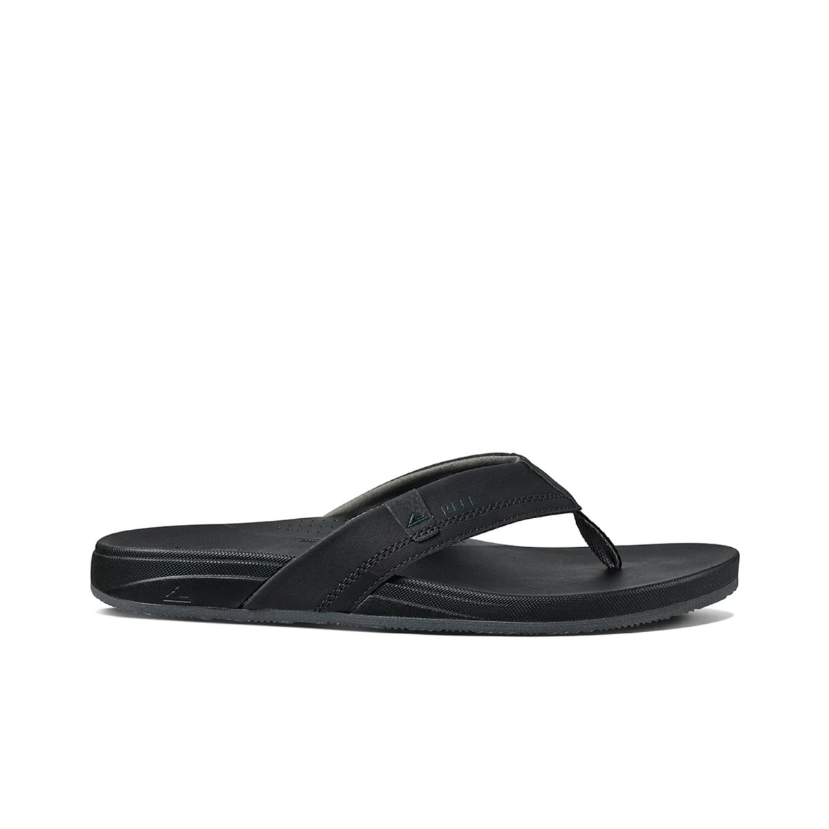 The REEF Cushion Spring is a black flip-flop sandal featuring thick synthetic leather straps, subtle stitching, a small logo on the strap, and a textured sole. Its minimalistic design offers casual style and essential arch support for enhanced comfort.