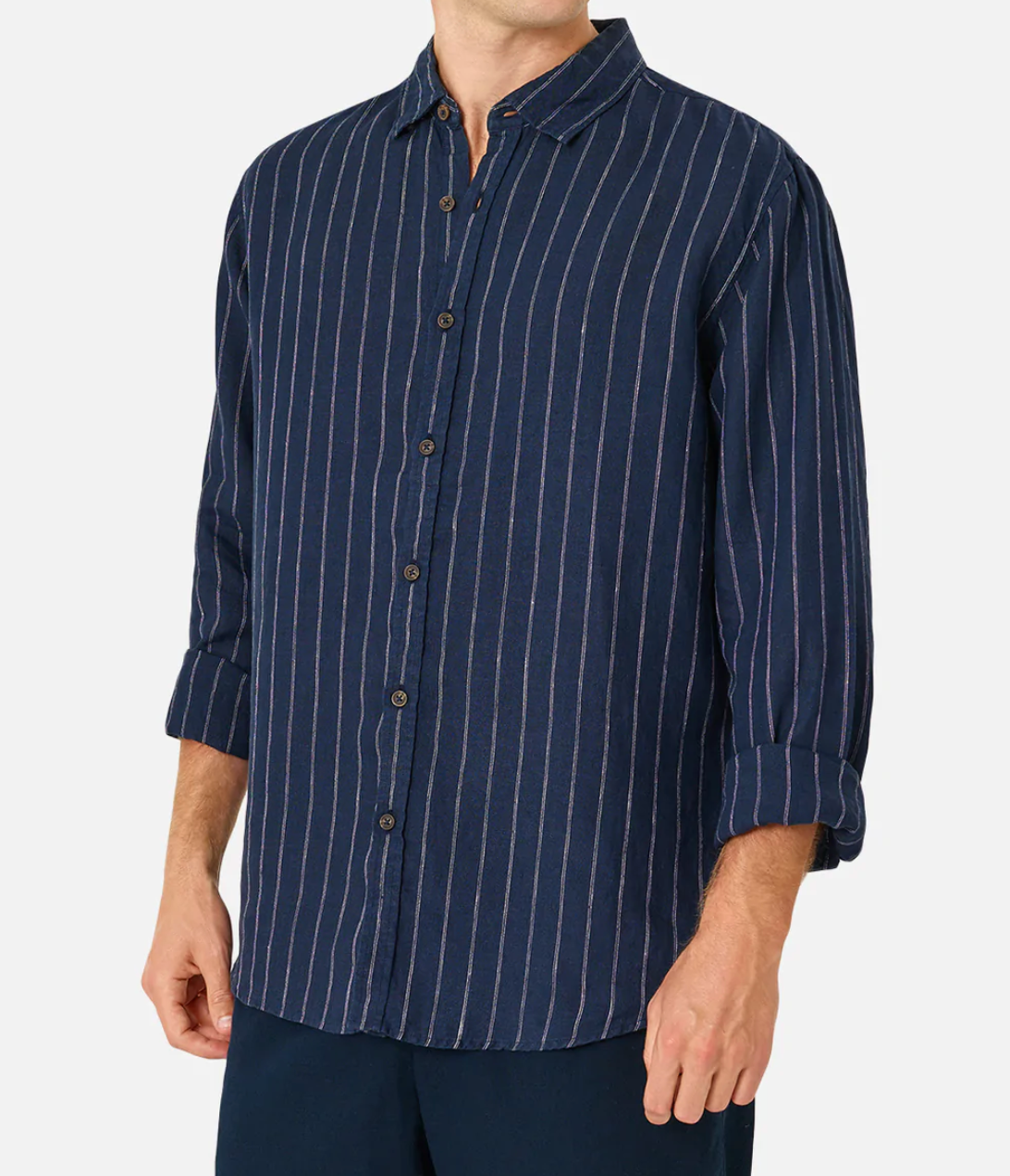 Someone wearing the Industrie The Giacomo Linen Shirt—a classic fit, long-sleeve navy linen shirt with white vertical stripes and a button-down front, sleeves rolled up. Dark blue pants complete the look on a plain white background.