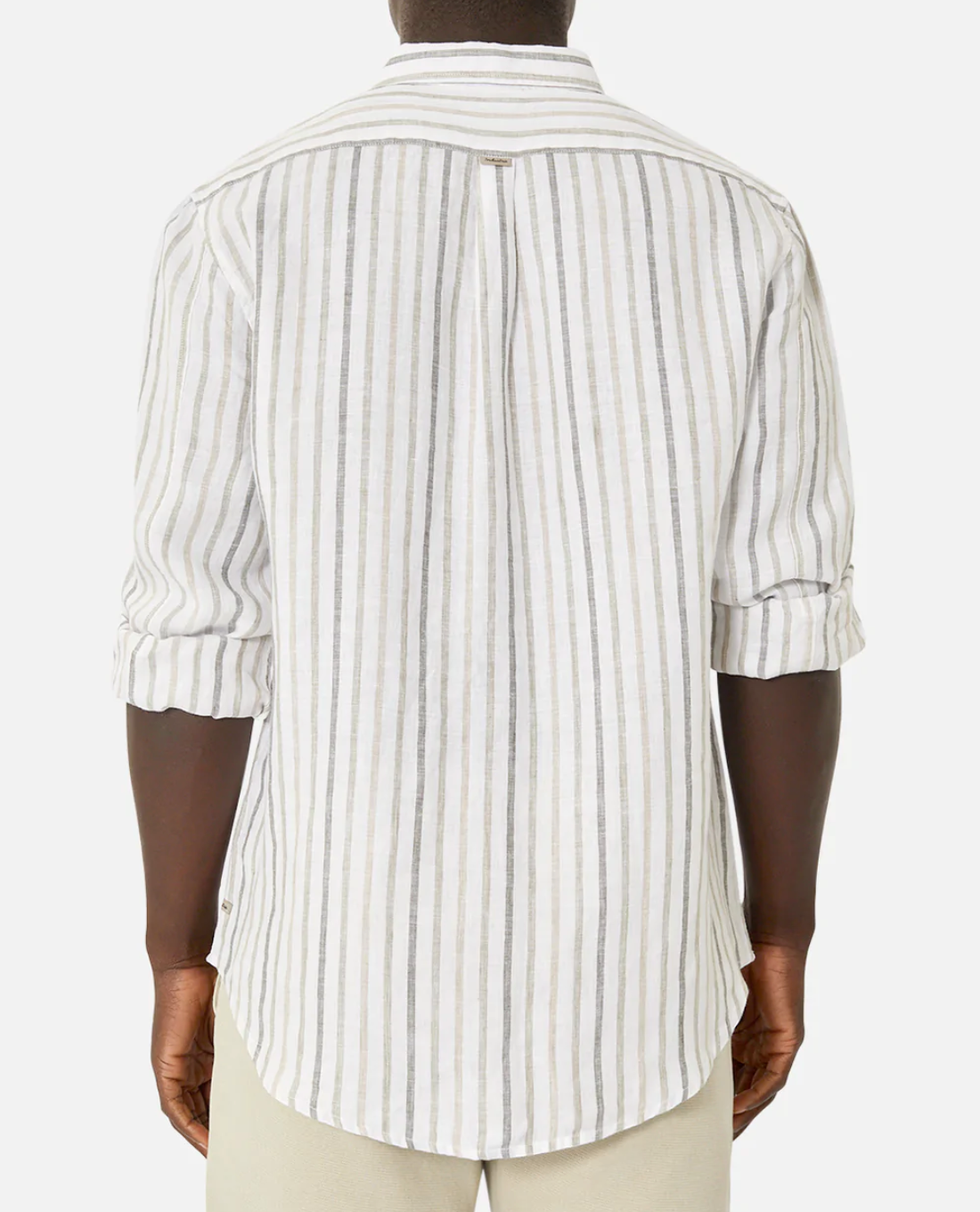 Rear view of a person in the Industrie The Webster Long Sleeve Shirt, featuring a relaxed fit and white-gray vertical stripes. The button-down collar shirt has rolled-up sleeves and is paired with light pants against a plain white background.