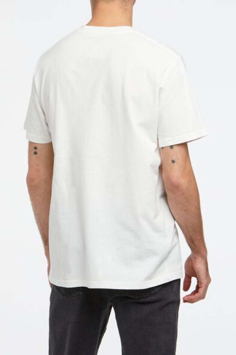 A person is seen from the back wearing a Wrangler Classic Logo Tee, made of 100% cotton, paired with dark jeans. They have small tattoos on their arms against a plain white background.