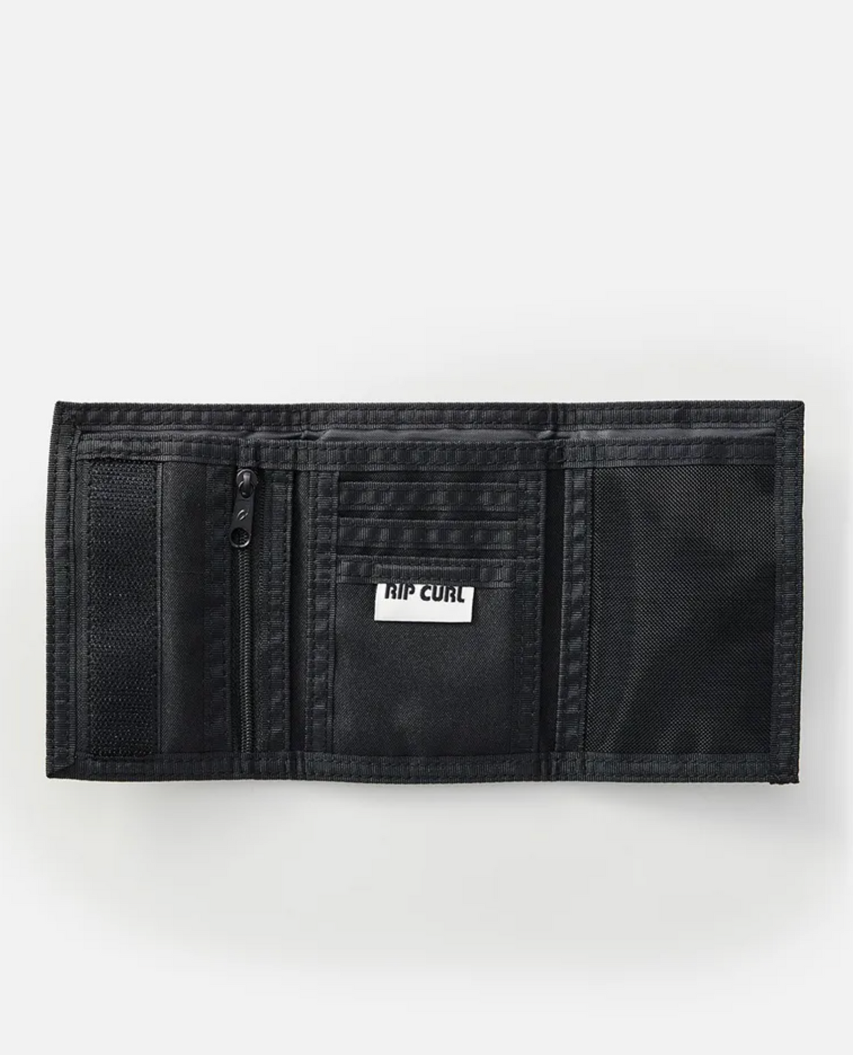 The Rip Curl Surf Revival Surf Wallet, made from recycled polyester, features multiple compartments including a zippered pocket, card slots, and a mesh section. It showcases its interior with the "RIP CURL" logo in white.