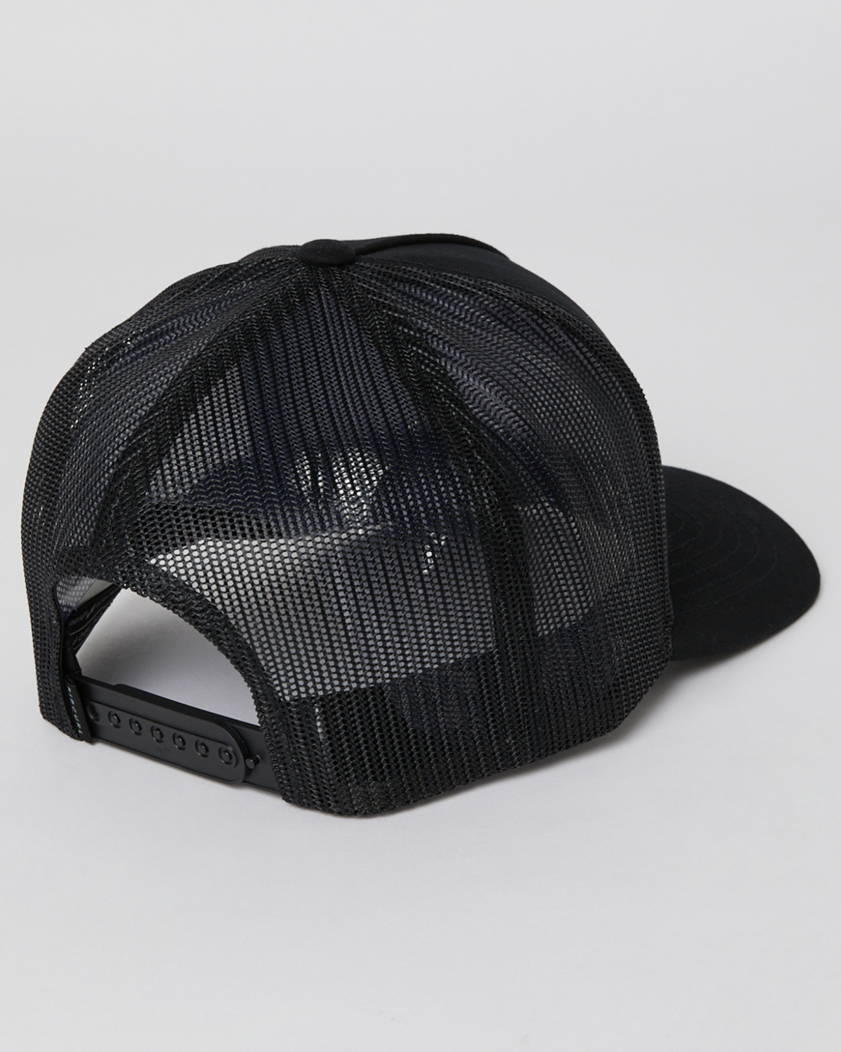 The Rip Curl Icons Eco Trucker cap, shown from the back against a plain background, is black and made of recycled polyester twill. It features a mesh panel and an adjustable snapback closure.