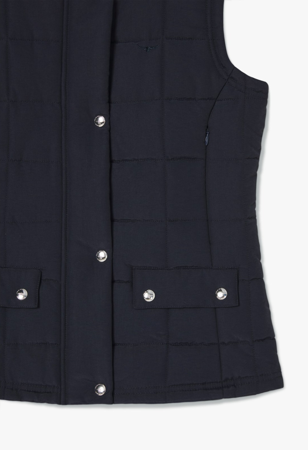 The RM Williams Wilpena Creek Vest is beautifully displayed against a white background, highlighting its quilted navy blue design with silver snap buttons down the front, two flap pockets with snap closures at the waist, and subtle horizontal stitching.