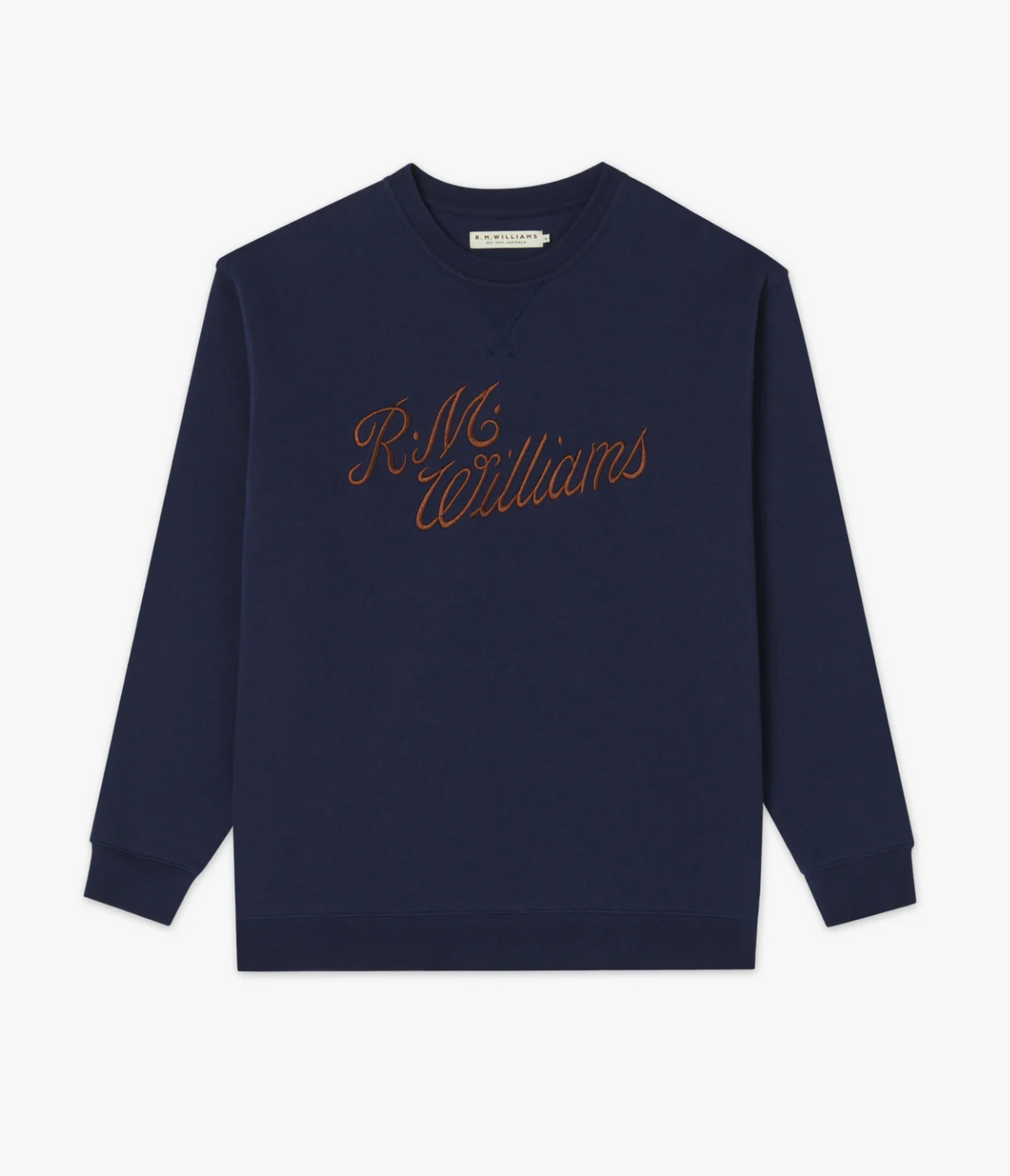 The RM Williams Script Crew Neck is a navy jumper featuring “R.M. Williams” script embroidery in orange across the chest, crafted from soft cotton blend fleece with long sleeves and ribbed cuffs and hem.