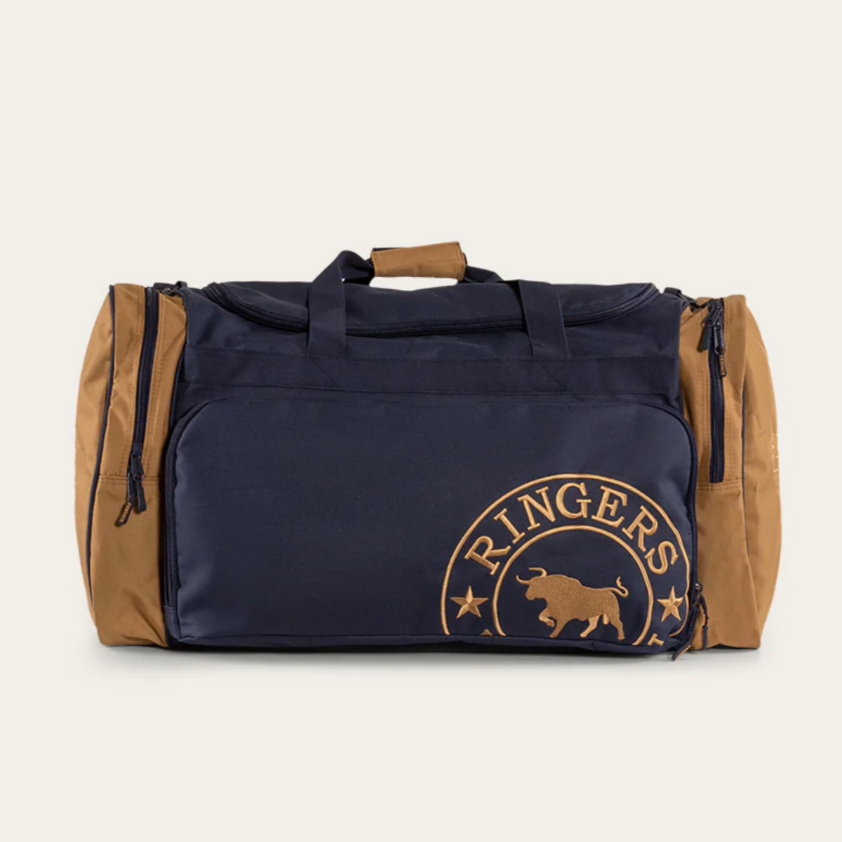 A Ringers Western Rider Sports Bag in navy blue and tan, displaying a circular logo with "RINGERS WESTERN" along with a bull and stars, set against a plain background. The sports bag features multiple zippered compartments and a handle on top.