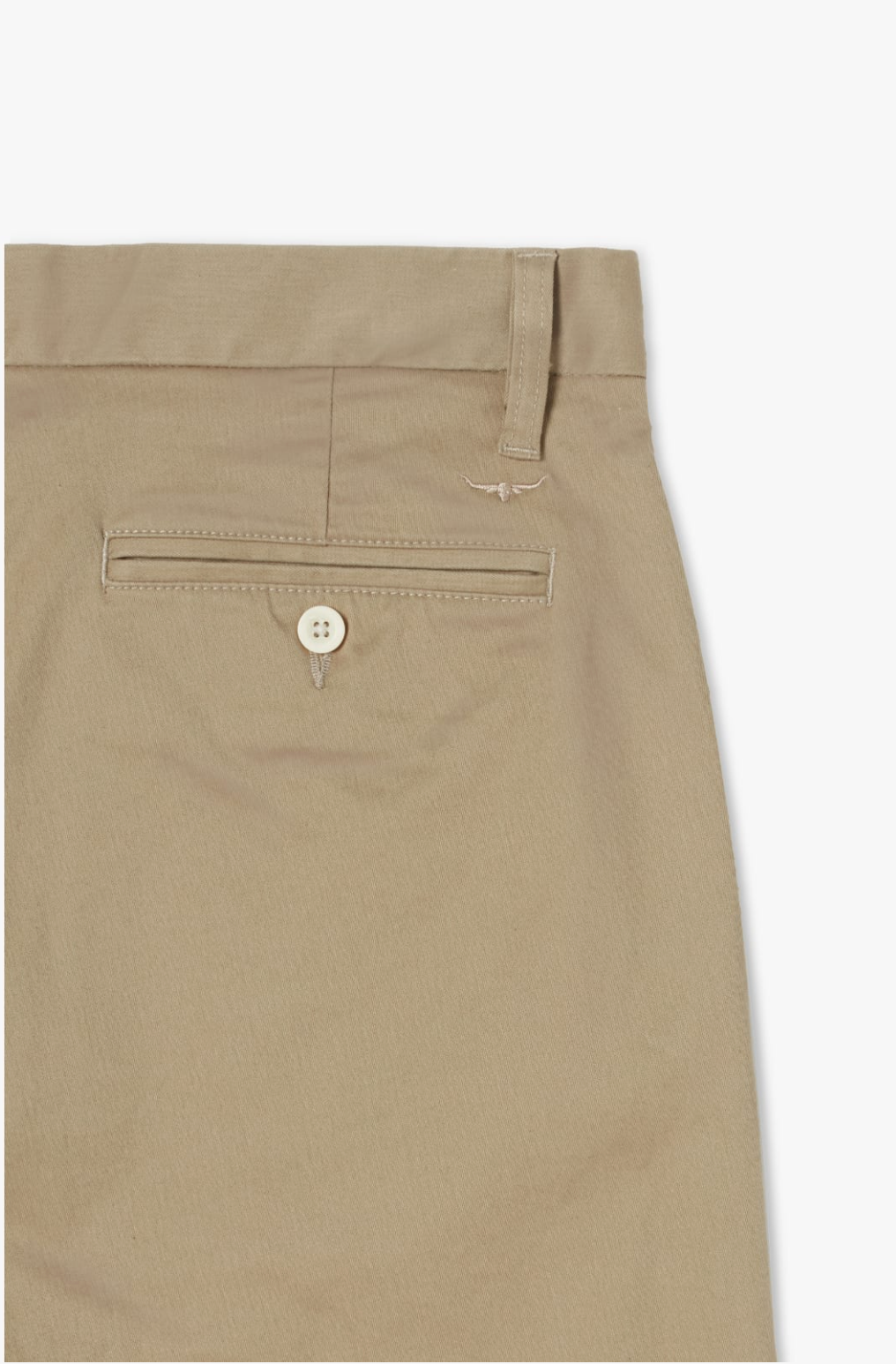 Close-up of the back pocket of the RM Williams Stirling Chino trousers. The pocket features a button closure with a small decorative emblem above it. The waistband includes a belt loop, and the fabric appears to be lightweight, slightly textured, and crafted from stretch cotton for added comfort.