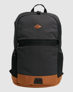 The Billabong Norwest Pack features a black and brown design with a front zipper pocket and a small brown diamond-shaped leather patch. Equipped with ergonomic shoulder straps, it ensures comfort, while side mesh pockets and a padded laptop compartment add practicality.
