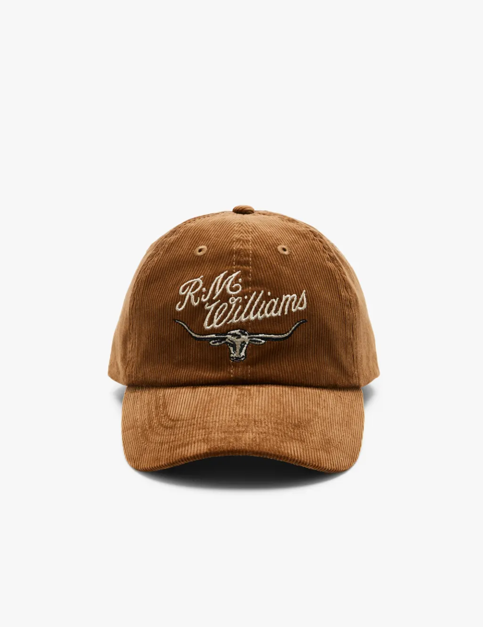 The RM Williams Corduroy Longhorn Cap showcases a brown cotton corduroy design with "R.M. Williams" embroidered above a bold longhorn skull graphic, all set on a plain white background for added distinctive charm.