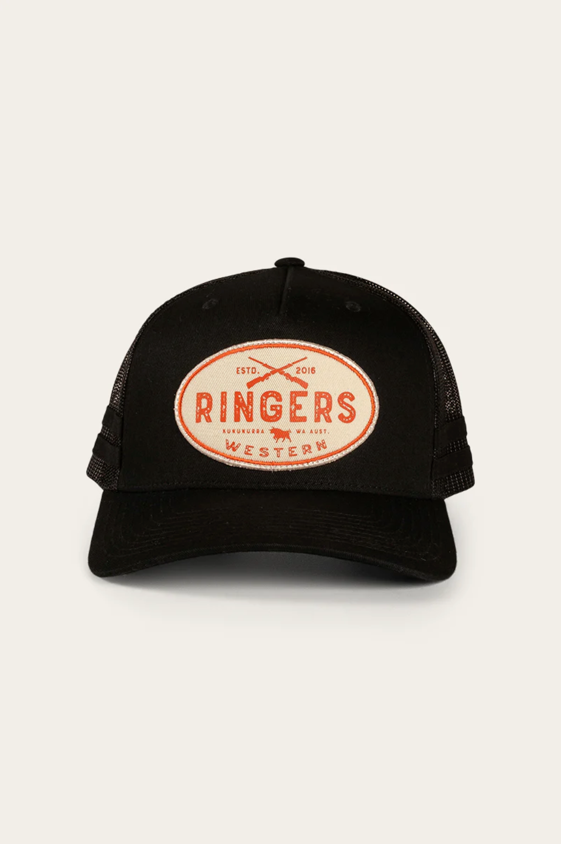 The Ringers Western Deacon Trucker Cap has a black cotton twill front, breathable mesh back, and curved brim. An oval patch with "RINGERS WESTERN" in red and crossed branding irons stands out on the front.