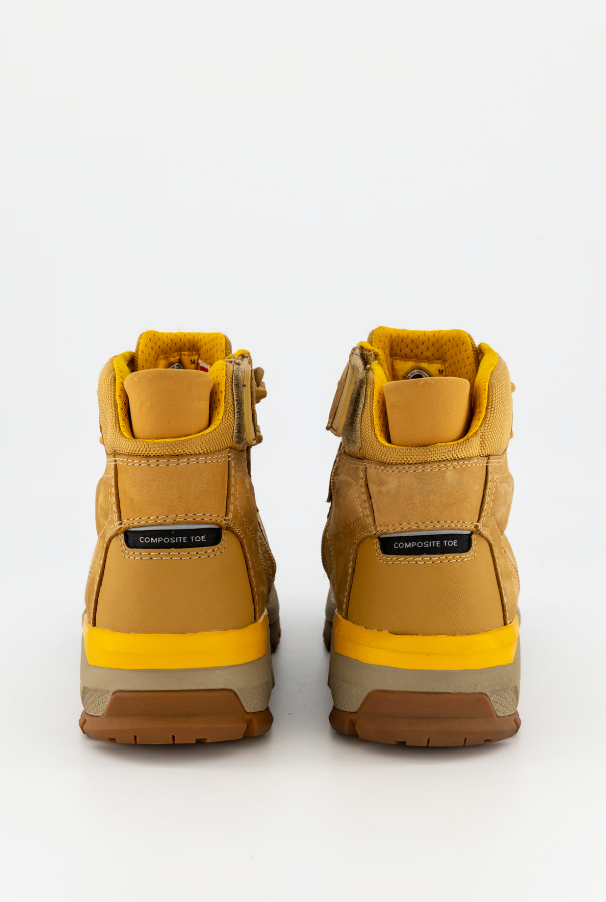 The CAT Propulsion CT Zip Work Boot in yellow showcases a textured surface with visible stitching. Designed with a rugged, brown rubber outsole, these composite toe boots offer slip-resistant soles and enhanced ankle support, set against a plain white background.