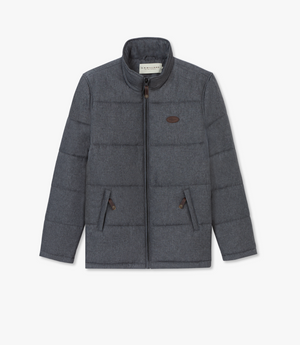 The RM Williams Patterson Creek Jacket is a gray, padded, quilted puffer with a full front zipper, two zippered side pockets, a stand-up collar, and a logo patch on the left chest. It's water-resistant and stands out against the plain white background.