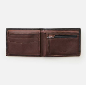 An open brown leather Rip Curl Ridge PU All Day Wallet is shown on a white background. It has card slots on the left, a zippered coin pocket on the right, and "RITUAL" embossed, blending elegance and functionality similar to the Rip Curl's PU All Day Wallet collection.