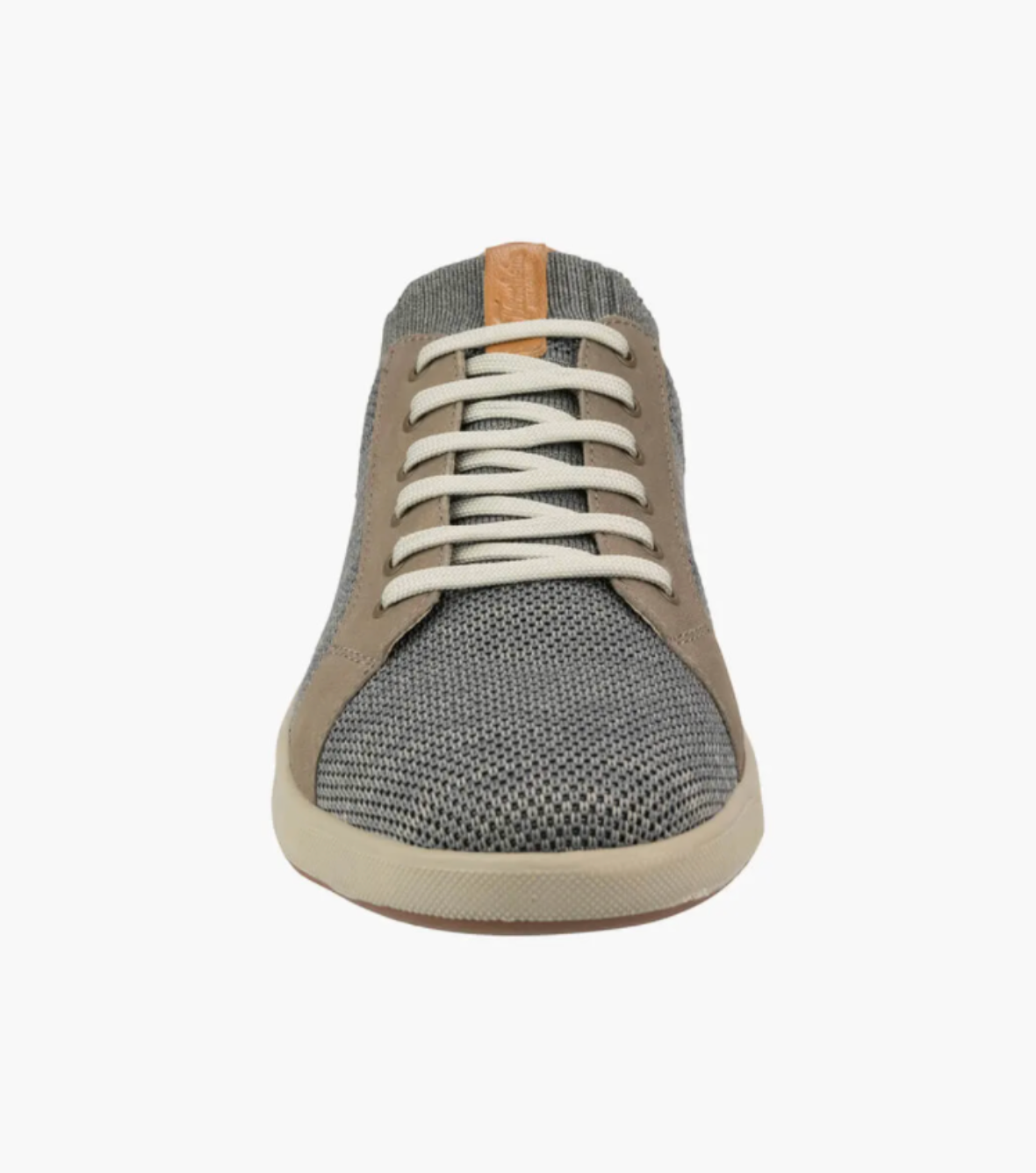 The Florsheim Crossover Knit is a casual low-top sneaker with a gray knit upper for breathability, light brown suede accents, and white laces. It has a cushioned footbed on a white sole and features a tan leather strip on the tongue.