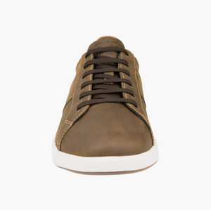 The Florsheim Crossover Lace Sneaker showcases a front view of its brown leather design with crossover dark brown laces, complemented by a slip-resistant white rubber sole, all set against a plain white background.