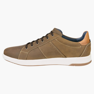 The Florsheim Crossover Lace Sneaker has a brown leather upper, black laces, and a white slip-resistant rubber sole. It features brown stitching and a tan suede heel accent, offering both style and functionality in its low-top design.