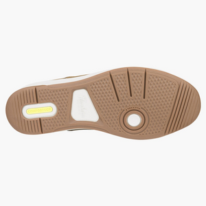 The image shows the sole of the Florsheim Crossover Lace Sneaker, with a brown slip-resistant rubber surface, textured pattern, grooves, a circular Flexsole logo, and a yellow Comfortech label. White and cream accents complete its stylish design.